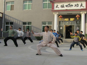 Chen Zhi Wei leading students in the school courtyard
